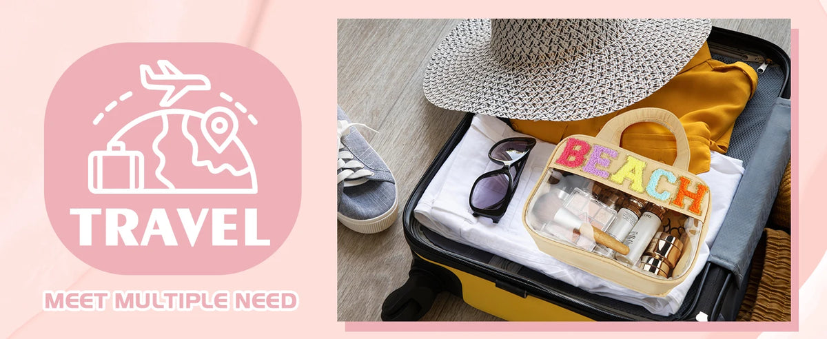 A clear makeup bag with a straw handle and a chenille letter design is shown inside an open suitcase.