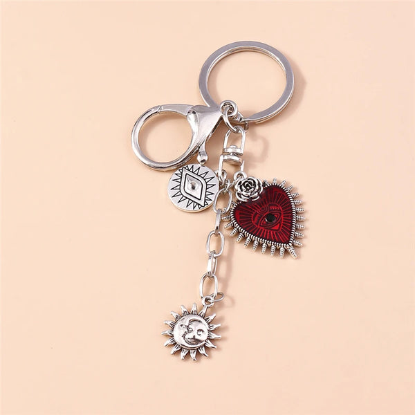 Silver gothic steampunk heart keychain featuring a sun eye pendant and decorative elements