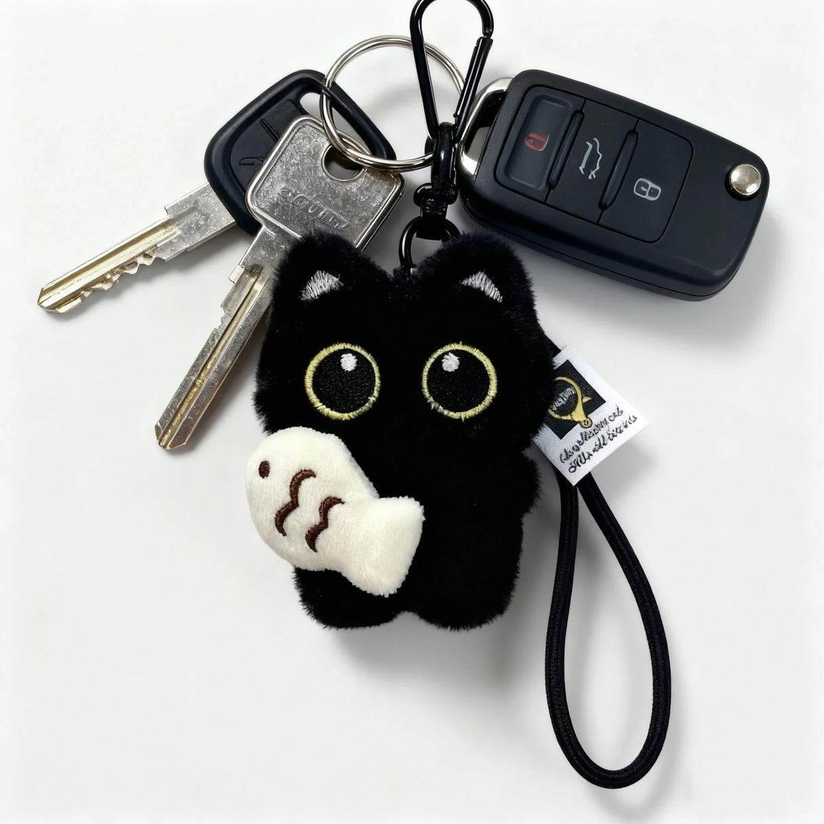 A set of black cat plush keychains and bag charms featuring a cute, fluffy cat head.