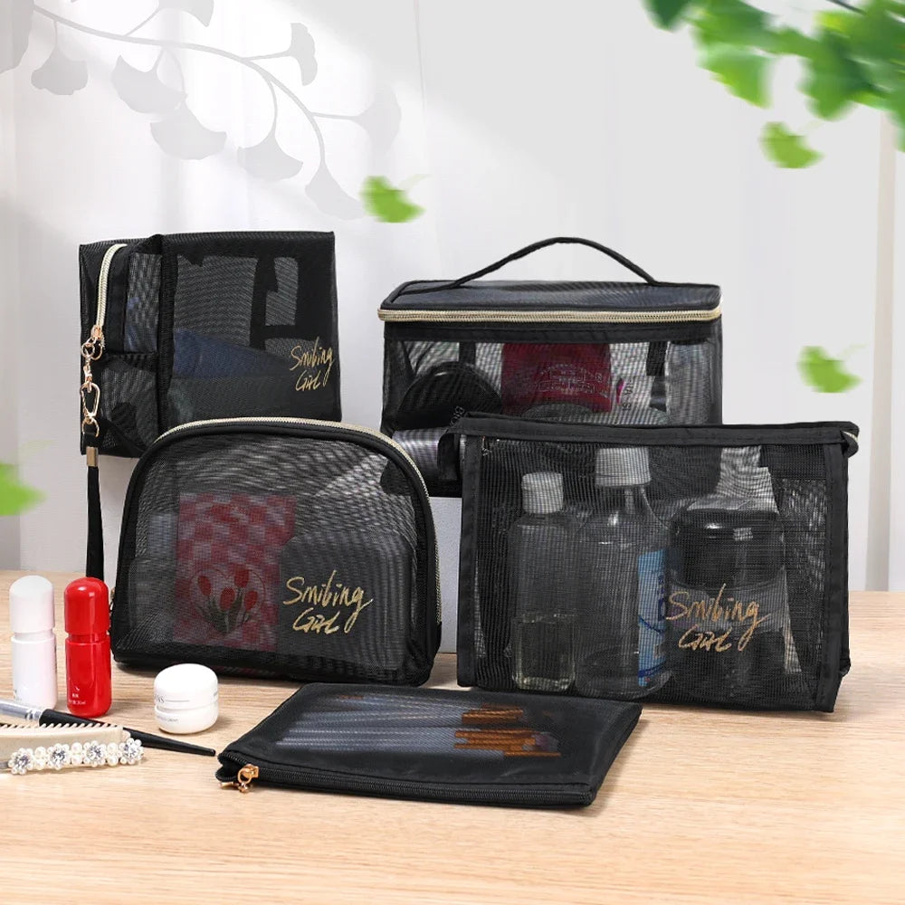 A collection of black mesh cosmetic storage pouches and a flat pouch are displayed on a wooden surface.
