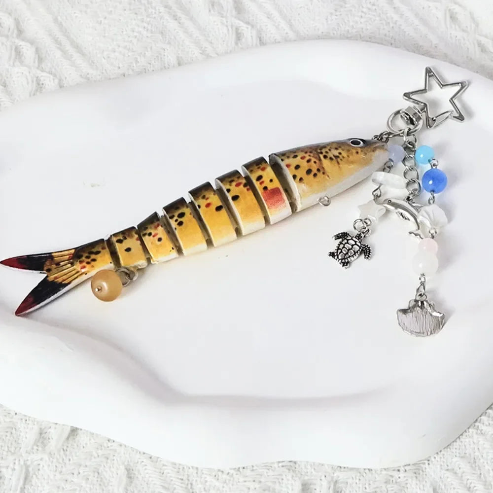 A simulation fish keychain featuring a realistic design with scales and a star charm.