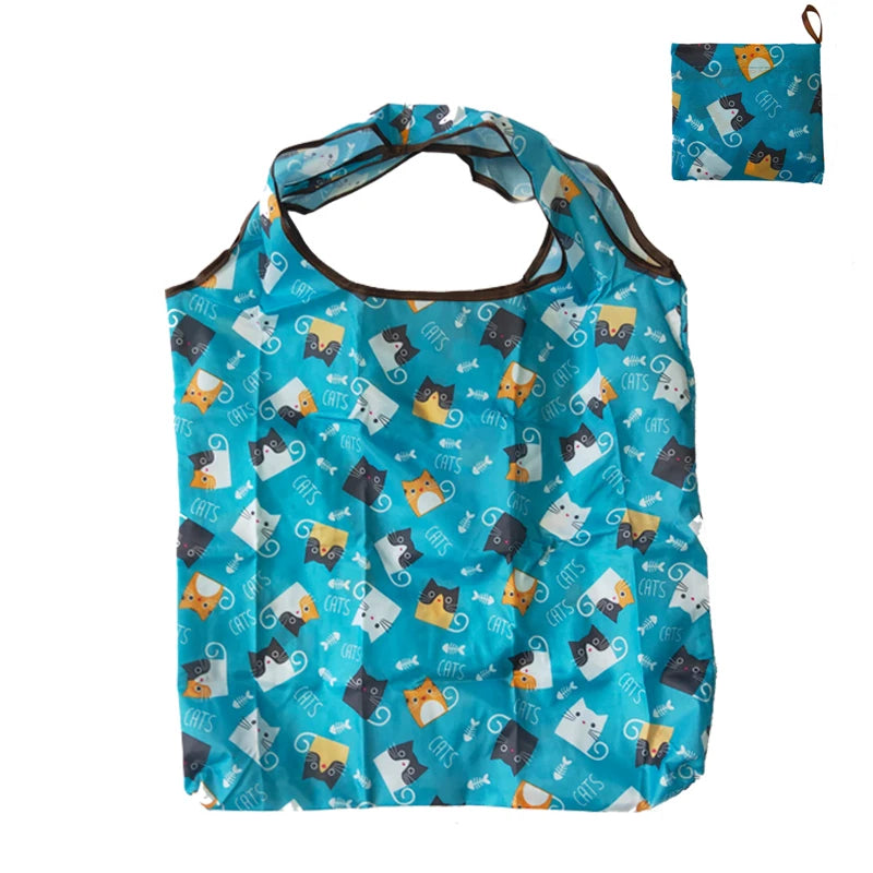 A teal nylon reusable tote bag featuring a pattern of cats and geometric shapes.