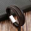 A dark brown multi-layer leather bracelet with textured beads resting on a wooden surface.