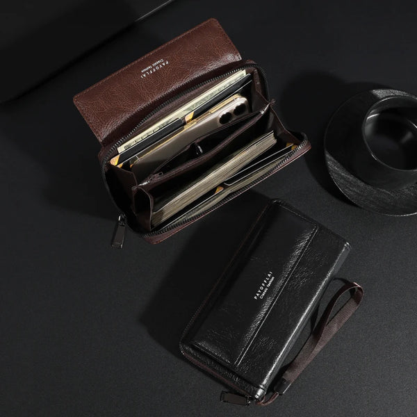 A brown leather zipper clutch wallet is open, displaying several cards and cash inside.