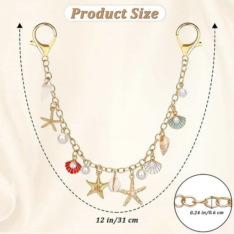 A delicate gold-toned necklace featuring various metal bag charms and pearl accents, measuring 12 inches long.