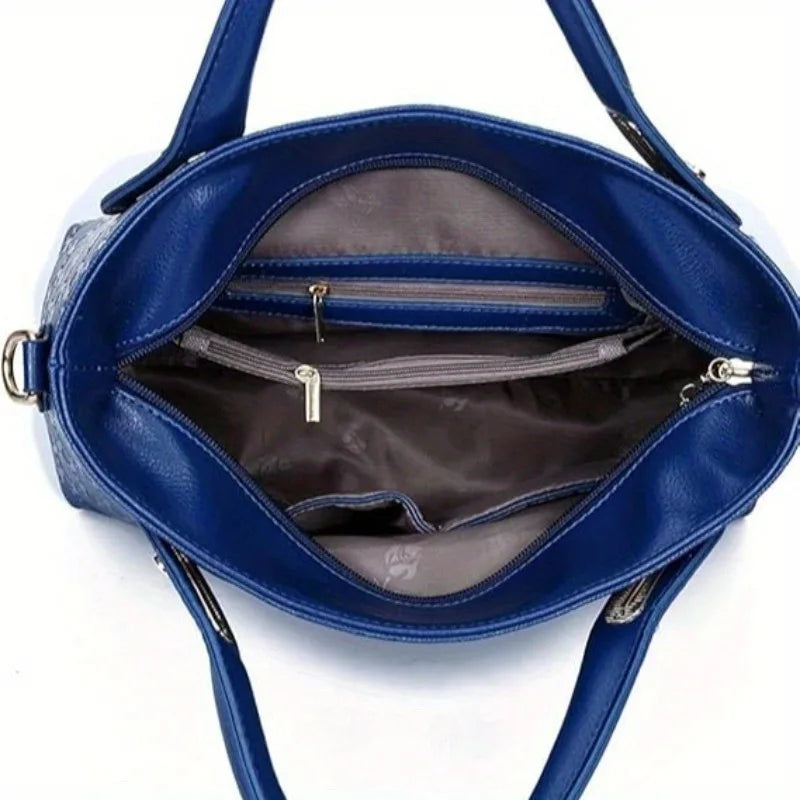 A deep blue leather handbag with a flap and interior pocket is shown open, revealing a zippered compartment.
