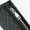 Close-up of a black leather handbag featuring silver hardware and a visible zipper detail.