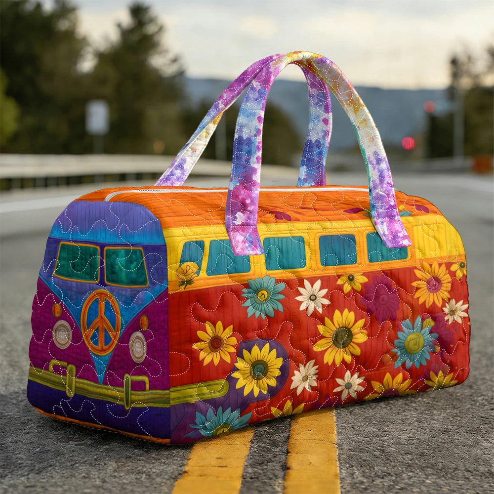 A vintage sunflower quilted duffle bag with purple handles rests on asphalt.