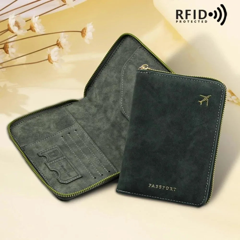 A dark green slim RFID blocking passport wallet and travel organizer with a zipper closure and leather trim.