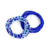 A stack of colorful belly bead chains featuring blue and turquoise beads for body jewelry.
