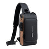 Schwarze Designer Anti-Diebstahl-Crossbody-Slingbag mit taner Lederakzent und schwarzem Riemen.