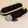 A black compact umbrella with a rhinestone sphere handle and UV protection tag.
