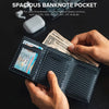 A hand holds a black card holder displaying various banknotes and cards.
