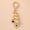 Gold pearl bow heart keychain with a jump ring and dangling beads for bags and keys