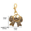 Gold-toned leopard print bow and heart bag charm keychain