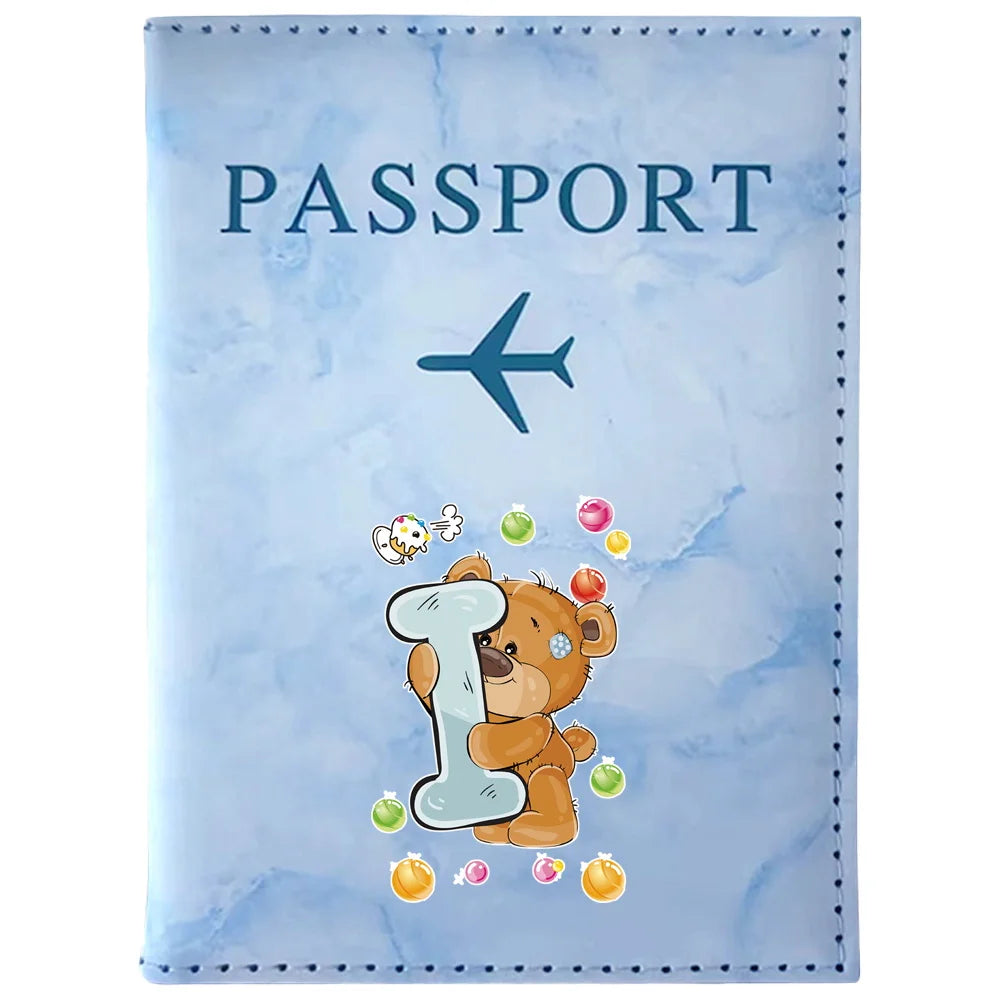 Light blue passport card holder featuring a vintage letter print of a teddy bear.