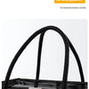 Black mesh drainage shower tote with a thick handle shown from the front.