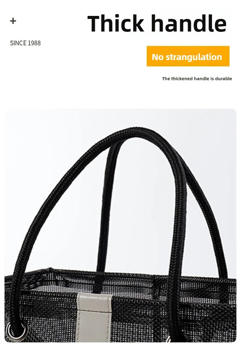 Black mesh drainage shower tote with a thick handle shown from the front.