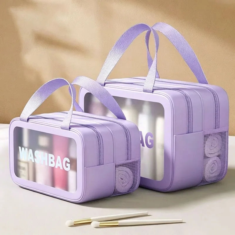 A purple travel toiletry bag with a clear window showing toiletries and a mesh pocket for separation.