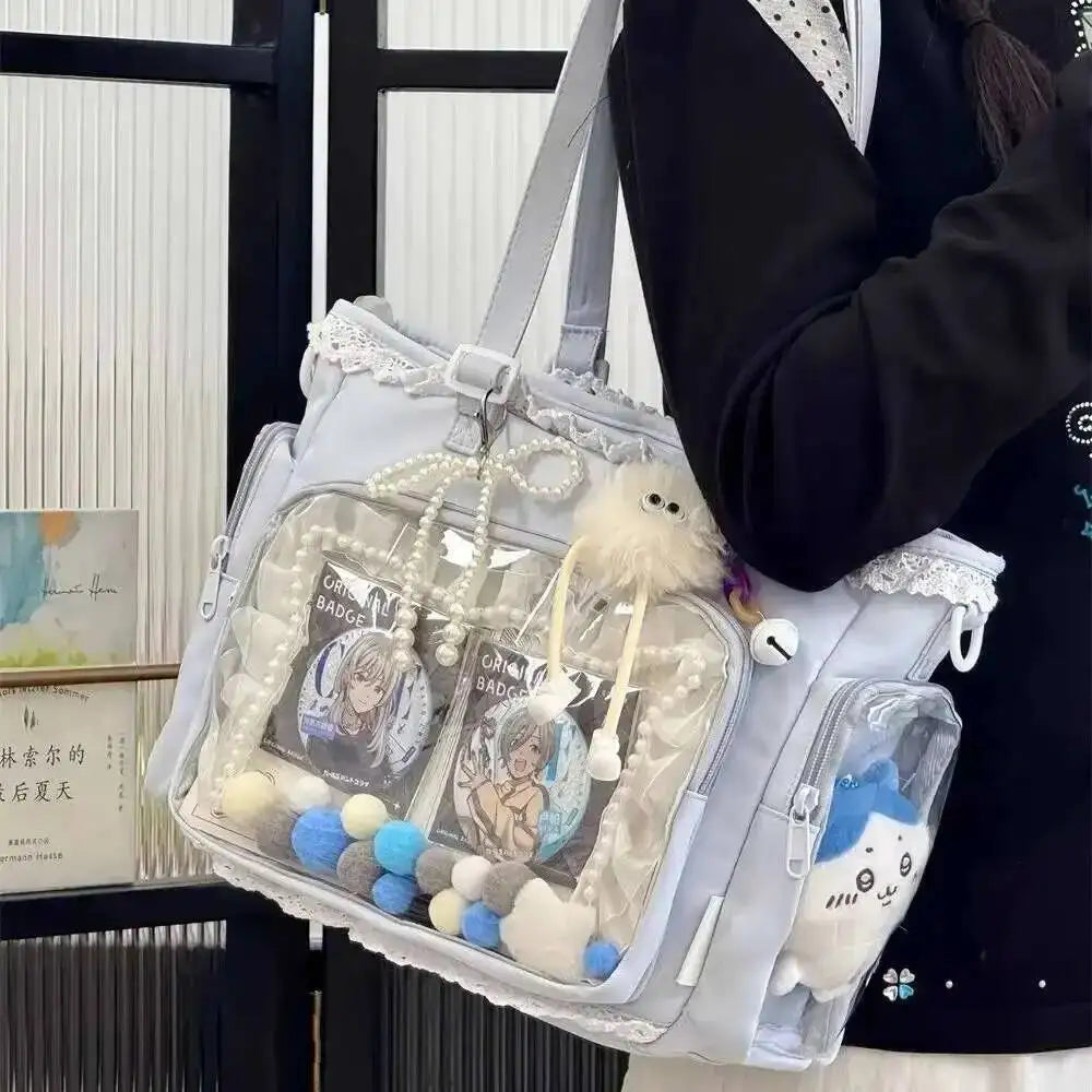 A transparent shoulder tote bag with decorative elements and a fluffy white charm is shown against a dark background.