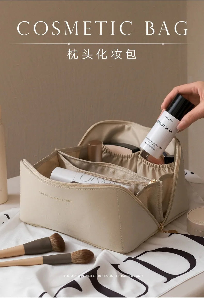 A hand is opening a beige cosmetic bag, revealing a cylindrical product inside.