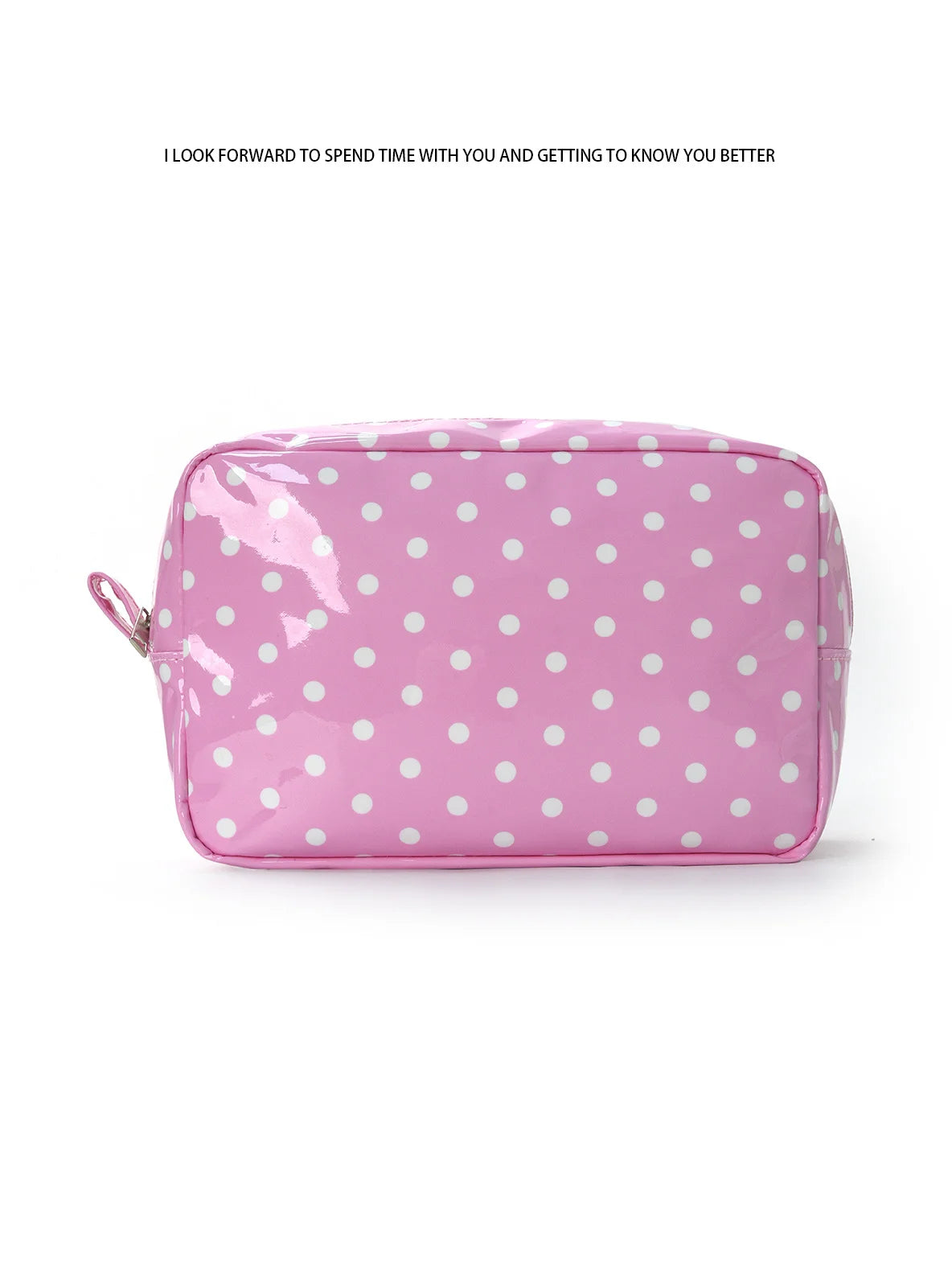 A pink cosmetic storage bag with white polka dots lying flat on a white background.