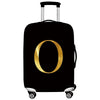 Black rolling suitcase with a gold letter O design and a black protective cover.