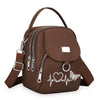 Sac bandoulière floral marron et durable avec fermeture éclair et motif cœur sur le devant.