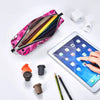 A pink leather pencil case is open, showing several colored pencils and a white electronic device next to a tablet.