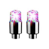 A pair of LED tire valve stem lights with clear lenses and metallic bases.