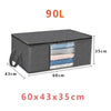 A dark gray foldable storage bag with a clear window showing folded fabrics, measuring 60x43x35 cm.