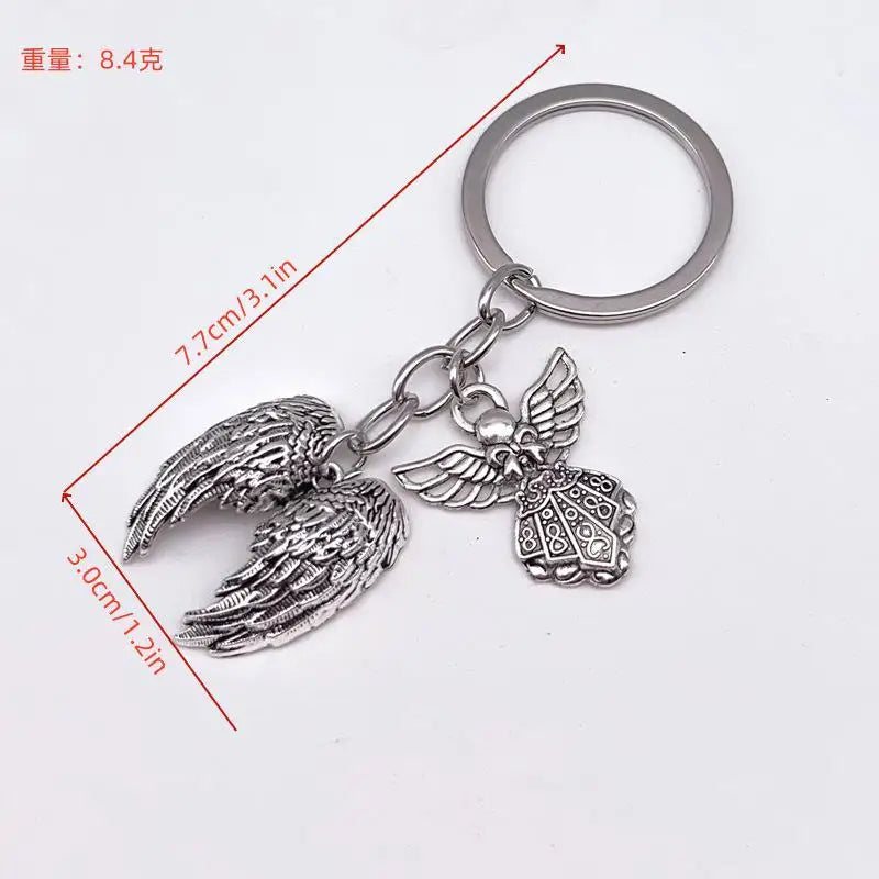 Silver metal angel wing keychain charm with a circular keyring
