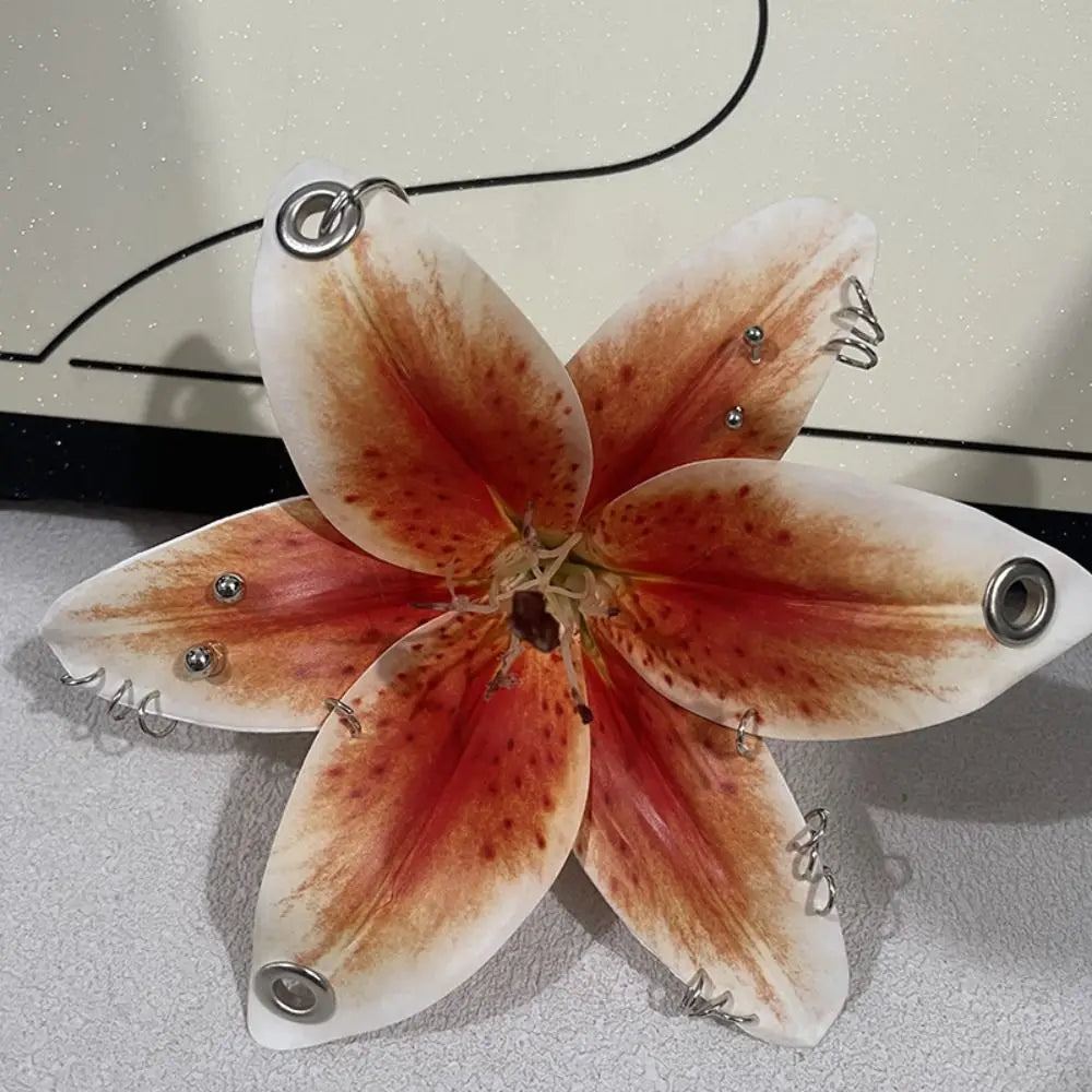 A realistic Phalaenopsis orchid flower shaped keychain with warm orange and brown tones.