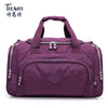 A purple nylon travel duffle bag with silver zippers and handles.