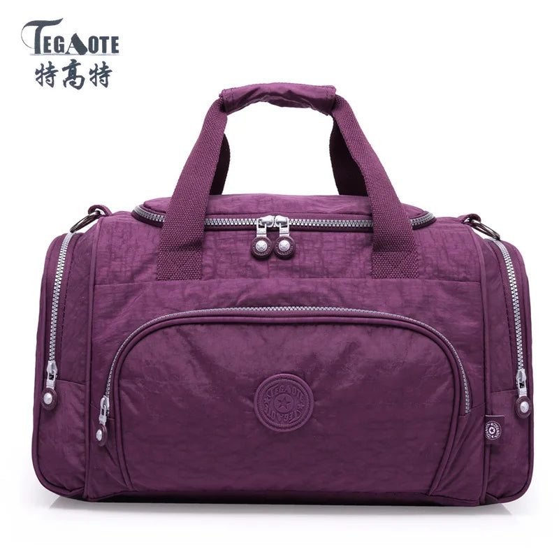 A purple nylon travel duffle bag with silver zippers and handles.