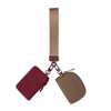 A mini nylon zip wristlet coin purse with a tan strap and a maroon fabric pouch.