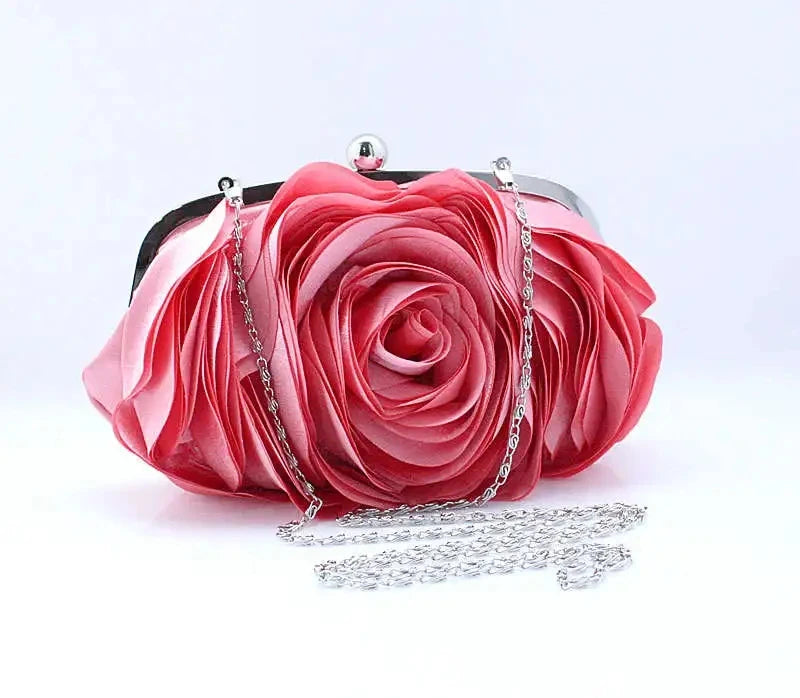 A vibrant pink rose floral evening clutch bag with a silver chain strap.