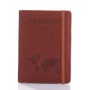A brown leather passport organizer with embossed text and a world map design.
