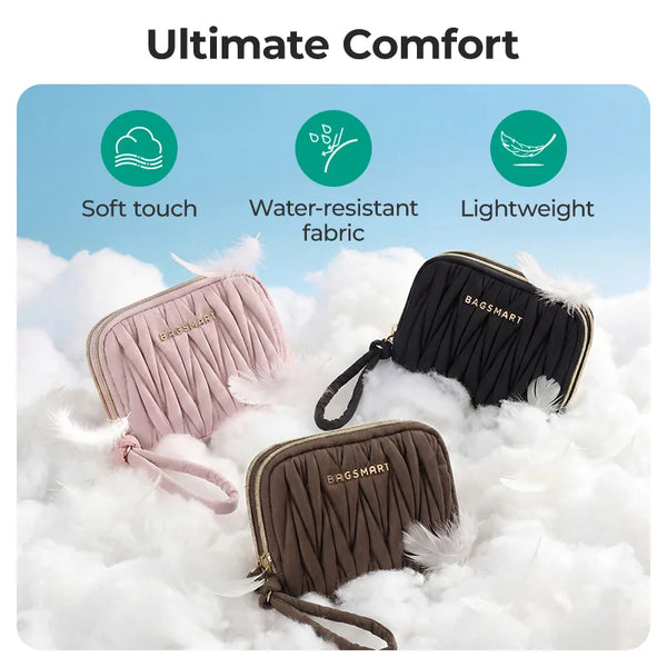 Three versions of a soft fabric coin purse or card holder wallet in pink, black, and brown resting on white fluffy material.