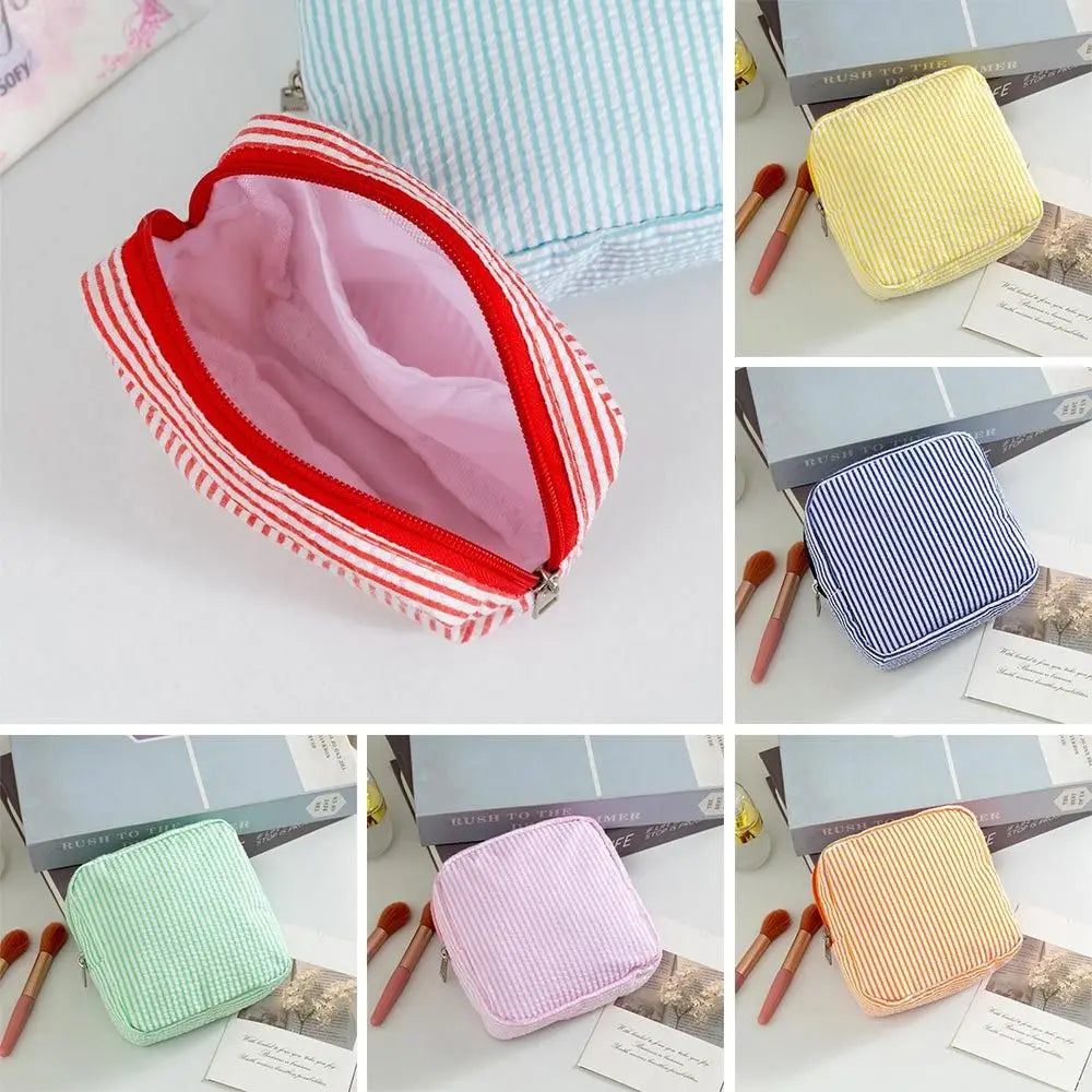 A collection of multi-functional storage pouches in various colors and striped patterns, including pink, yellow, blue, and gr