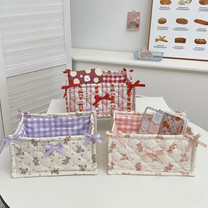 A collection of quilted cotton storage baskets featuring various floral and patterned designs.