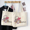 A cream canvas tote bag featuring a pink stethoscope and heart design with the name Madison printed on it.