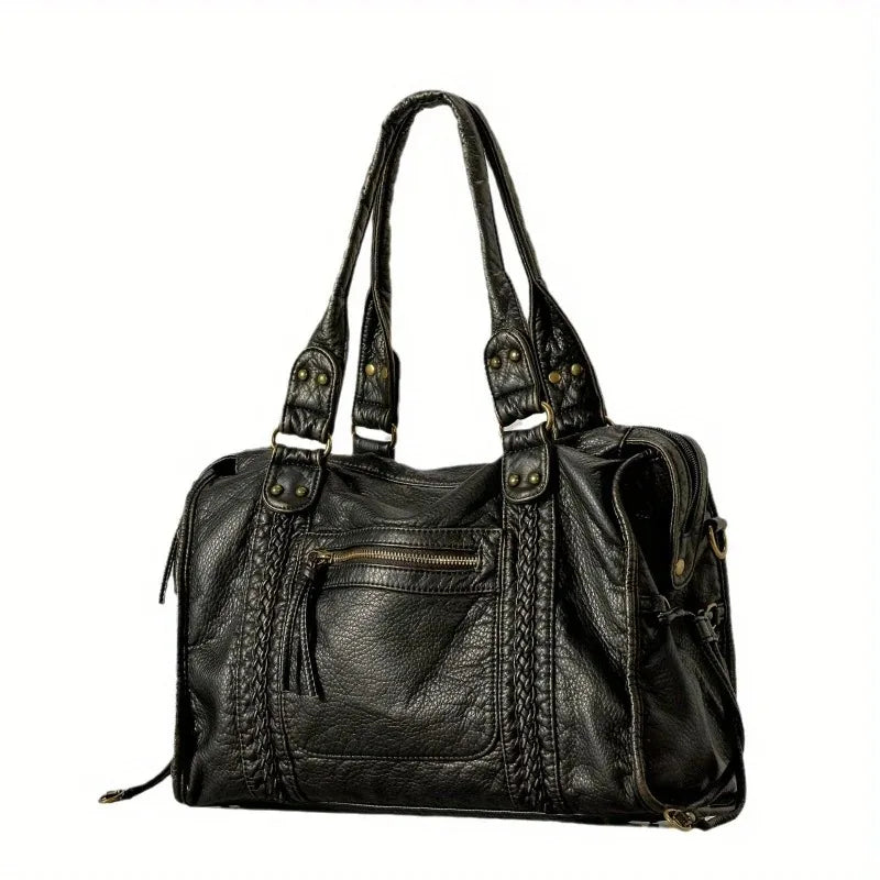 A black vintage washed leather tote bag with distressed detailing and leather handles.