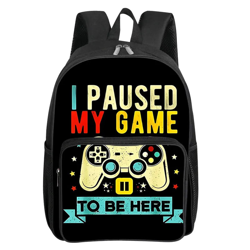 Black backpack featuring a graphic that says I Paused My Game to Be Here with a yellow controller icon.