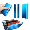 A blue stainless steel card holder with multiple cards inside, shown from a top-down angle.