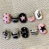 A collection of 30 cute cartoon press-on nails in various designs including glitter, black and white stripes, and pink with b