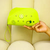 A hand holds a bright lime green silicone coin pouch with drainage holes against a light background.