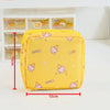 A yellow compact pouch designed for storing sanitary pads or tampons, featuring cute pink and yellow designs.