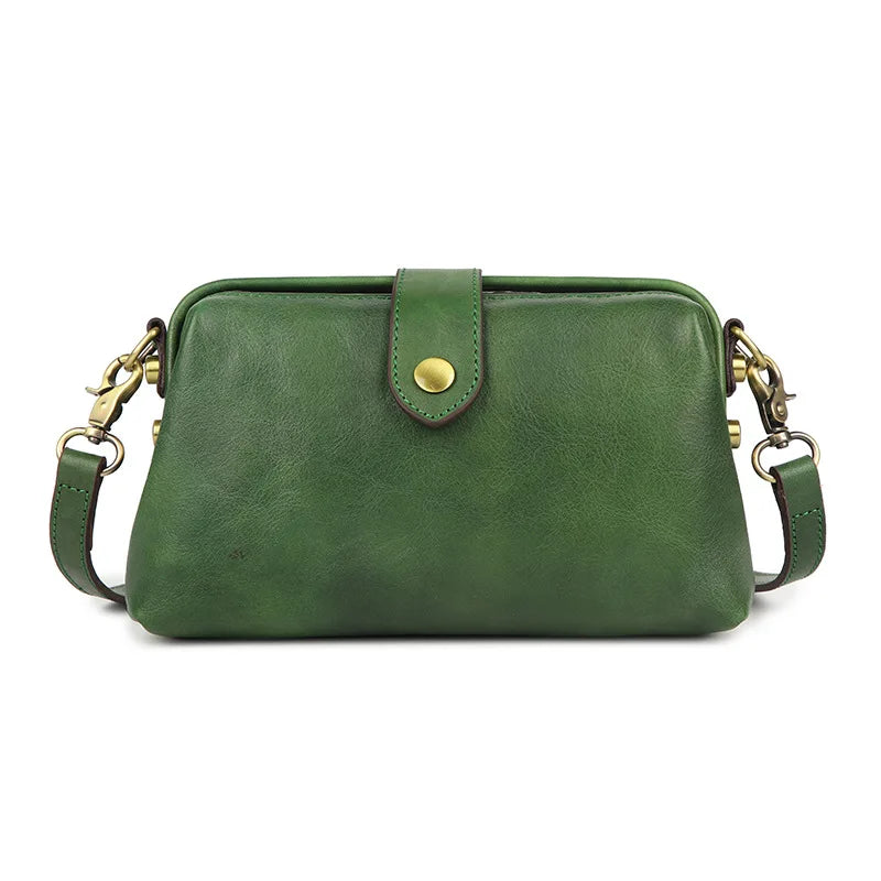 A dark green genuine leather crossbody bag with a brass buckle closure.
