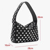 A black designer metal rivet shoulder bag with a polka dot pattern shown against a white background.
